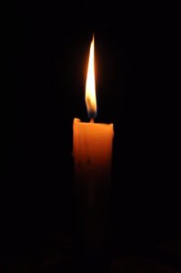 Candle that is lit and has a dark background